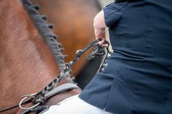 Para dressage rider using looped reins.